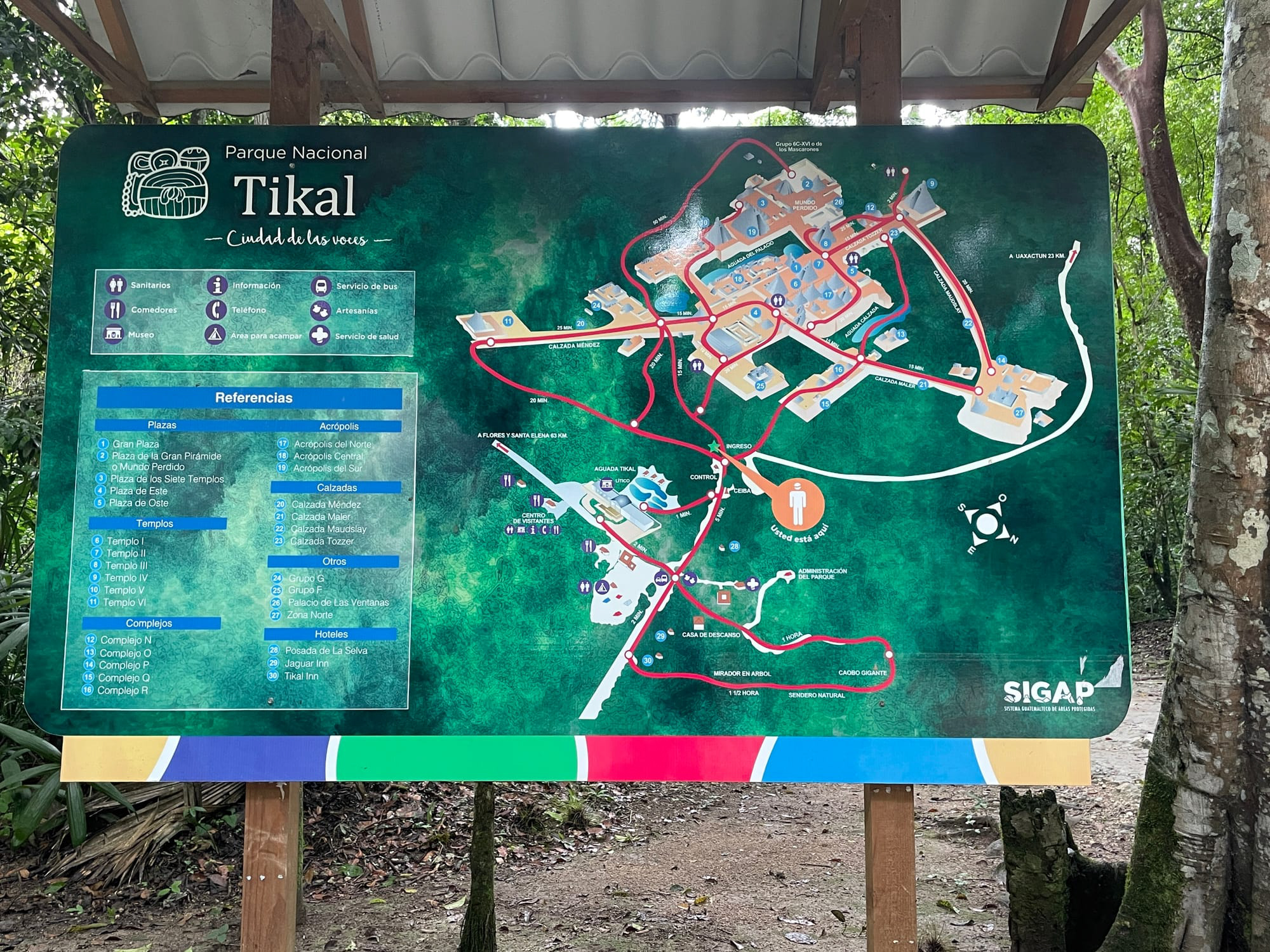 A detailed map of Tikal National Park displayed at the entrance, highlighting various plazas, temples, and other significant archaeological sites within the park.