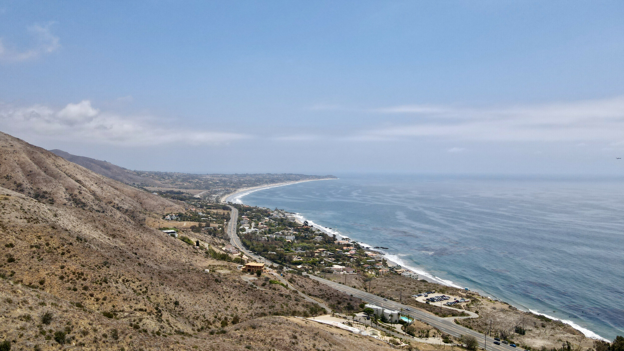 Aerial view of El Matador Beach with the Santa Monica Mountains and Point Dume in the distance, taken by a Mavic Air 2 drone.