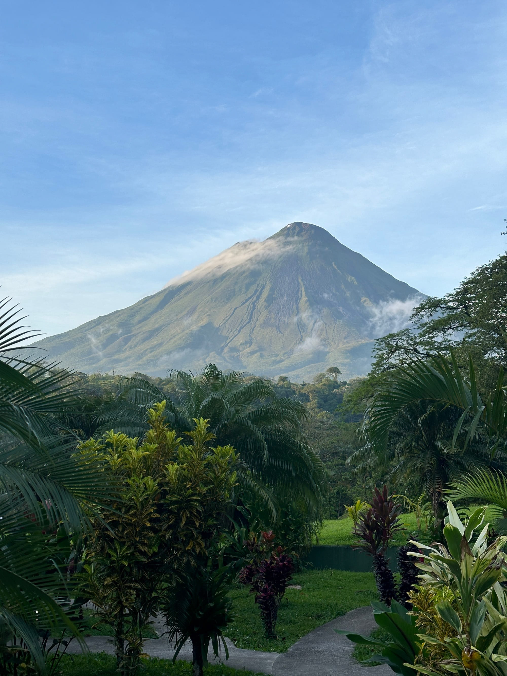  Costa Rica dawn: Arenal Volcano pierces mist, lush jungle at its feet.