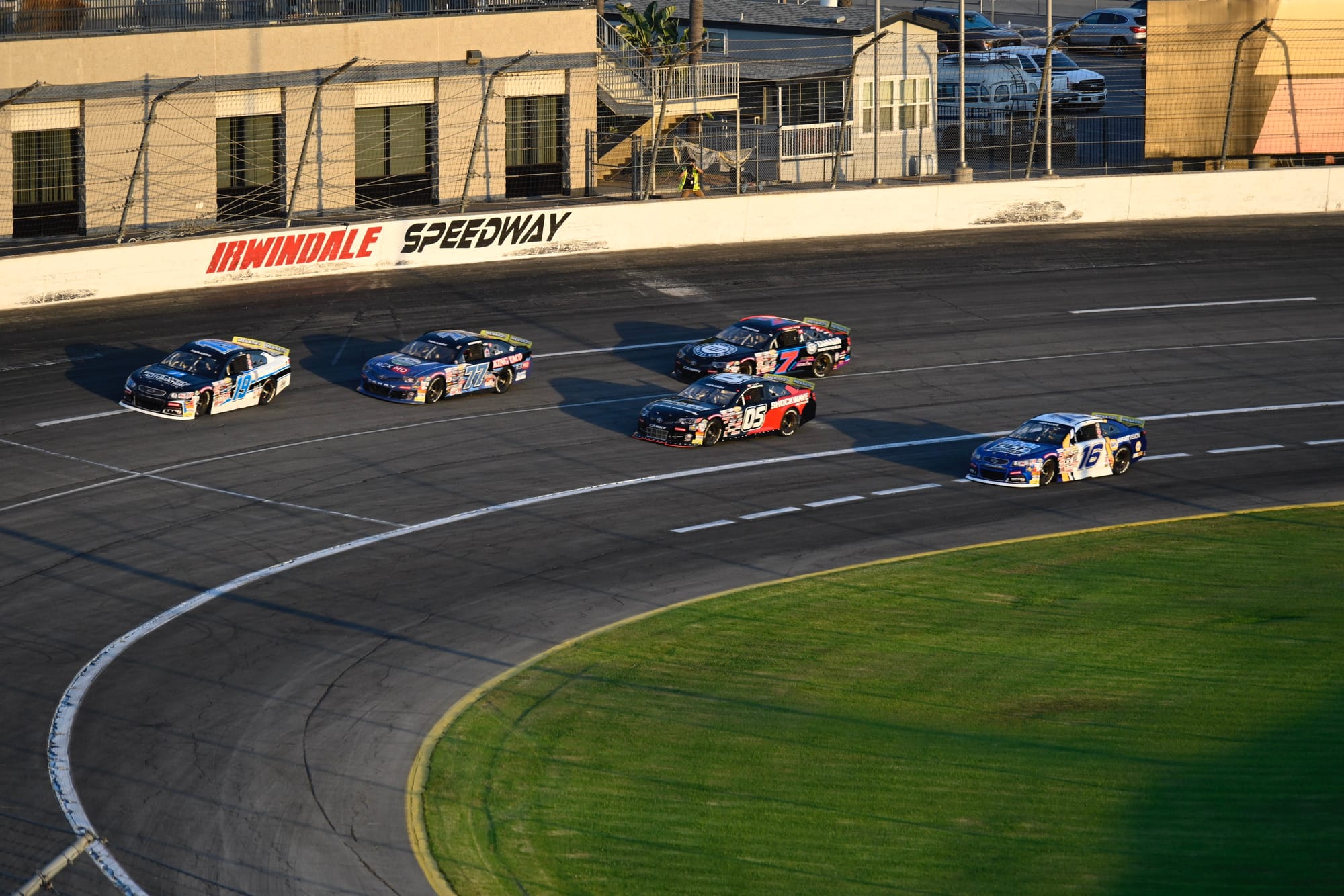 Race cars on track at Irwindale Speedway during Night of Destruction.