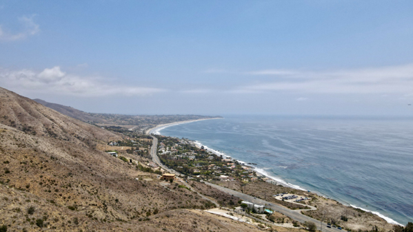 Aerial view of El Matador Beach with the Santa Monica Mountains and Point Dume in the distance, taken by a Mavic Air 2 drone.