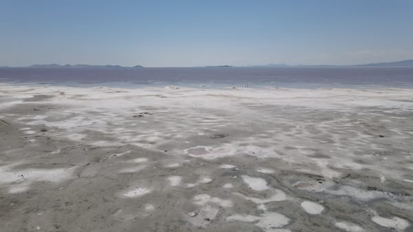  Panoramic view of the Great Salt Lake with pink waters and white salt flats.