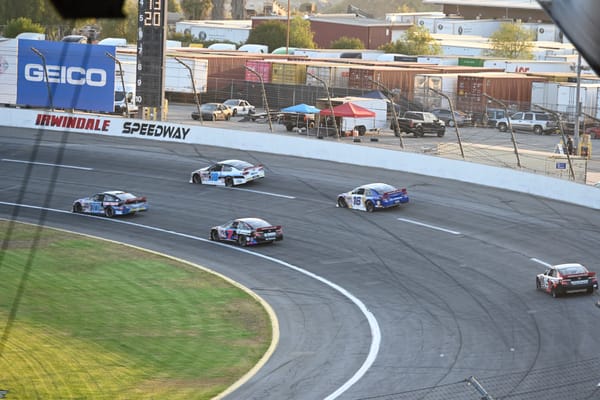 Cars racing on the track at Irwindale Speedway during the Night of Destruction event.